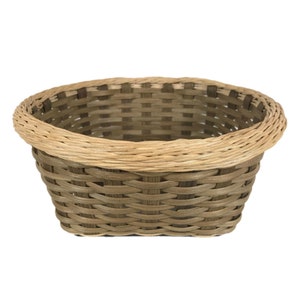 May include: A woven oval basket with a light brown rim and a darker brown woven body.