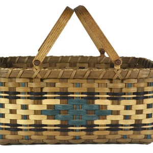 May include: A woven basket with a rectangular shape and a brown, black, and blue pattern. The basket has two wooden handles.