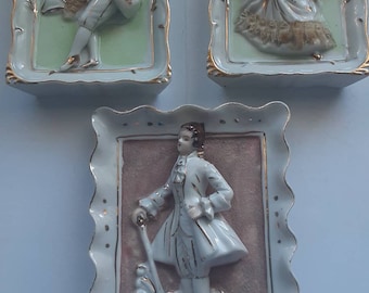 Porcelain, three small vintage frames representing characters from the French period, on a velvet background, new price.