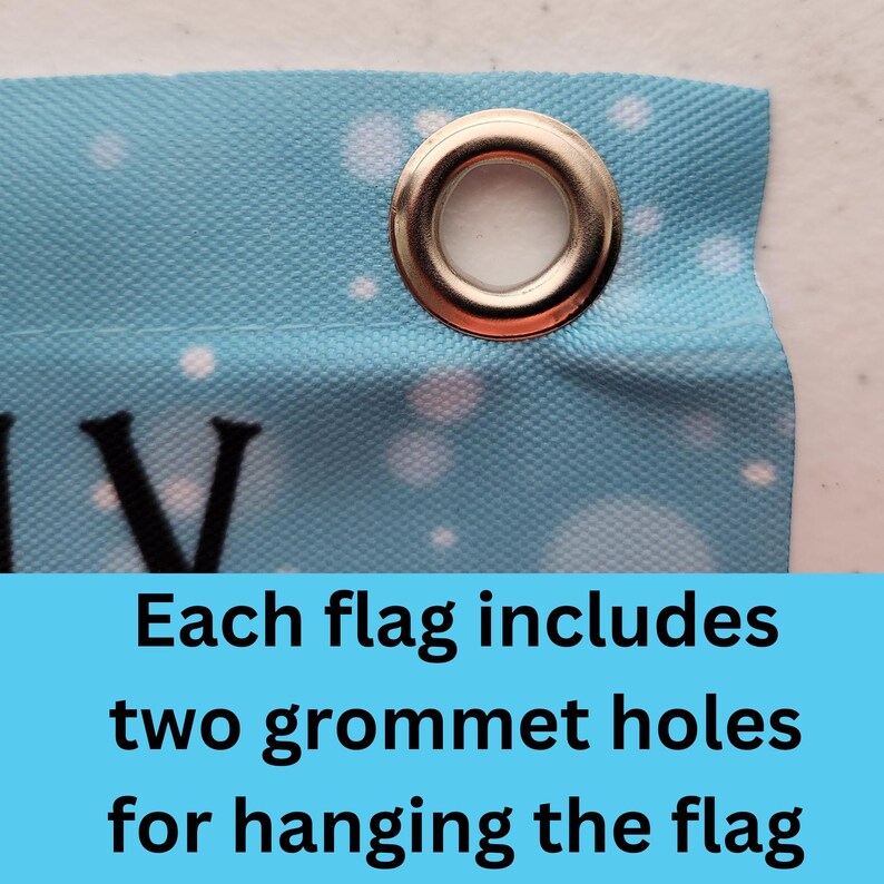 May include: Close-up of a blue fabric flag with white polka dots. The flag has a silver grommet hole in the top corner. Each flag includes two grommet holes for hanging the flag.