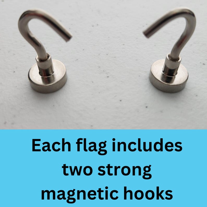 May include: Two silver magnetic hooks with a hook shape on top. Each hook has a round base. The text "Each flag includes two strong magnetic hooks" is below the hooks.