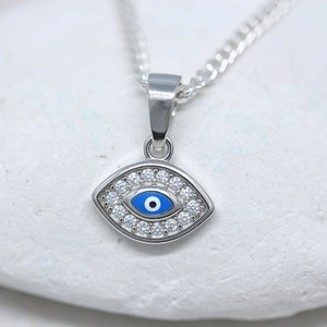 Sterling Silver Evil Eye Necklace. Evil Eye Encrusted with Cubic Zirconia Gems. Sterling Silver Evil Eye on a Sterling Silver Chain.