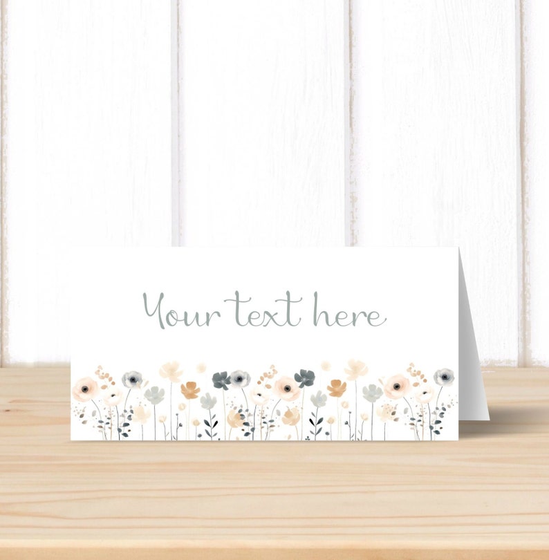 May include: A white card with a border of light blue, beige, and white flowers. The text "Your text here" is written in light blue on the card.