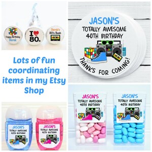 May include: A collection of party favors and decorations with an 80s theme. Includes Hershey's Kisses with custom labels, stickers, hand sanitizers, and candy containers. The text reads "Happy Birthday Derek", "I ❤️ 80s", and "Derek's 80's Bash".