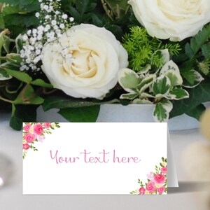 May include: White place card with pink floral design and the text "Your text here".