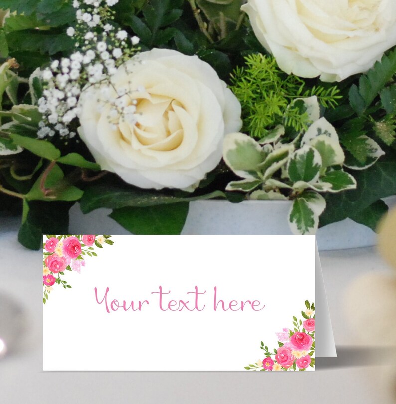 May include: White place card with pink floral design and the text "Your text here".