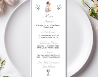 May include: A white menu card with a blue border, featuring a watercolor illustration of a young boy in a white robe. The menu lists the food options for a First Holy Communion celebration, including Caesar salad, grilled salmon, chicken nuggets, chocolate cheesecake, and the name "Liam Gilmore".