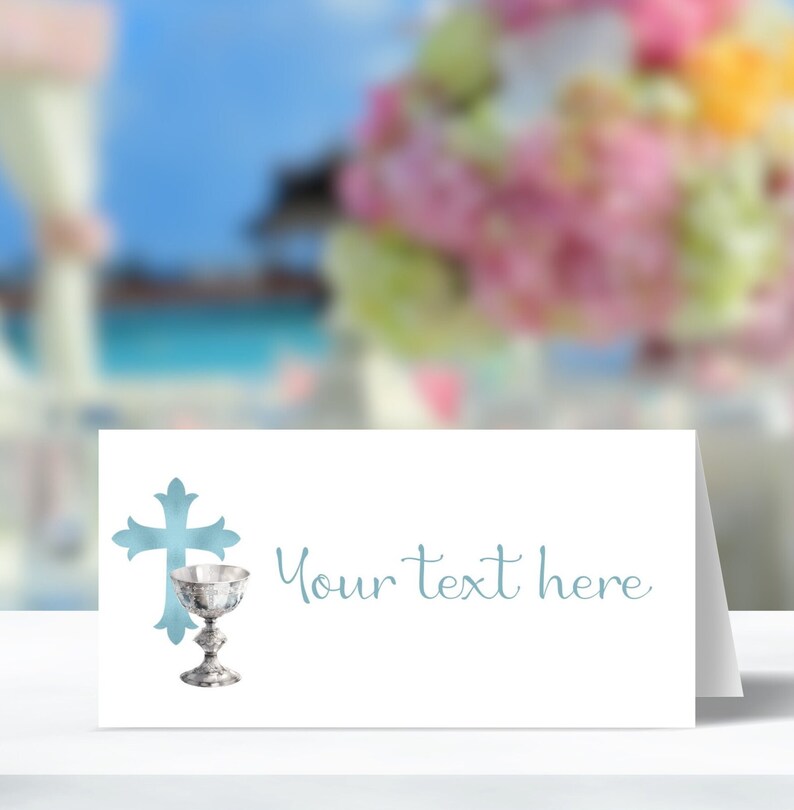 May include: White place card with a blue cross and chalice design. The text "Your text here" is printed in blue.