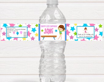May include: Water bottle label with a gymnastics theme. The label is white with colorful stars and the text "Happy 6th Birthday Jane". There is a cartoon image of a girl doing a handstand on a balance beam. The label also includes the text "Thank you for tumbling with me on this special day."