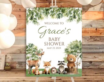 Op de afbeelding: Welkom bij Grace's Baby Shower-bord met een aquarel-bosmotief. Het bord toont een hert, vos, wasbeer, beer, eekhoorn en egel in een groene bosomgeving. De datum van de babyshower is 23 mei 2024.