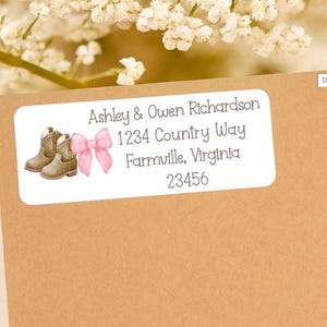 May include: A rectangular label in tan with the text "Ashley & Owen Richardson 1234 Country Way Farmville, Virginia 23456". The label includes illustrations of brown cowboy boots and a pink bow.