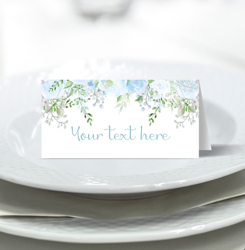 May include: A white place card with a blue and green floral design. The text "Your text here" is printed on the card.