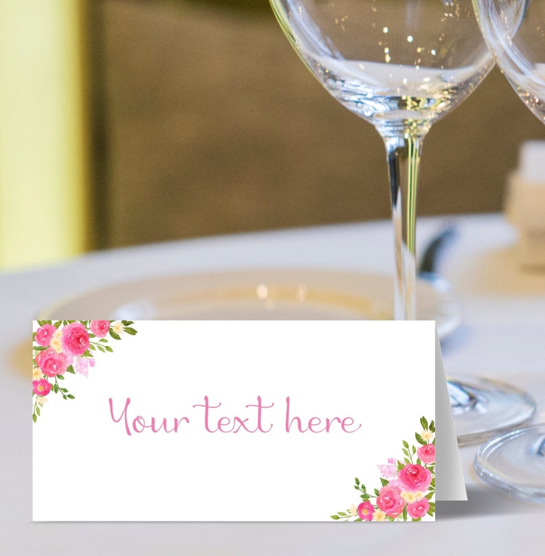 May include: White place card with pink floral design and the text "Your text here".