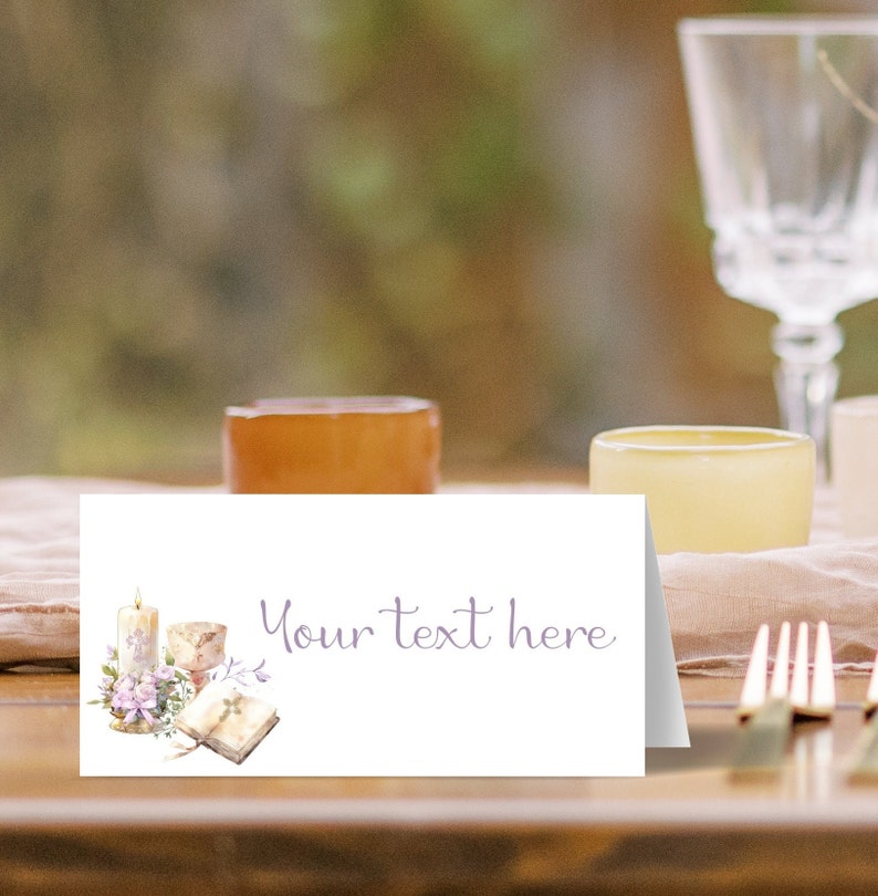 May include: White place card with a watercolor illustration of a candle, a chalice, and a book with a cross on it. The text "Your text here" is written in purple script.