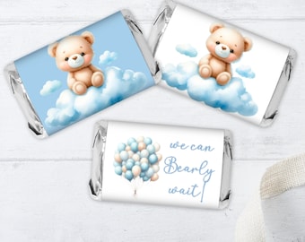May include: Three blue and white favor labels for baby shower favors. One label features a teddy bear sitting on a cloud with the text "We can Bearly wait!" Another label features a teddy bear sitting on a cloud with blue and white balloons. The third label features a teddy bear sitting on a cloud.