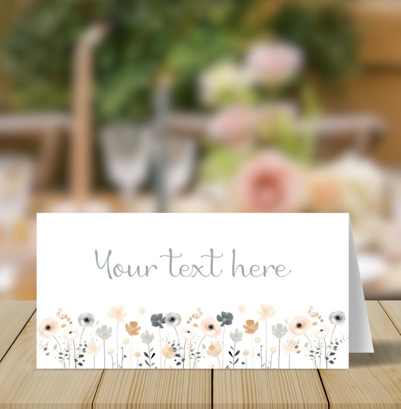 May include: A white card with a gray floral border and the text "Your text here" in gray. The card is on a wooden surface.