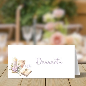 May include: White card with a purple inscription that reads "Desserts". The card is decorated with a watercolor illustration of a candle, a chalice, a book, and flowers.
