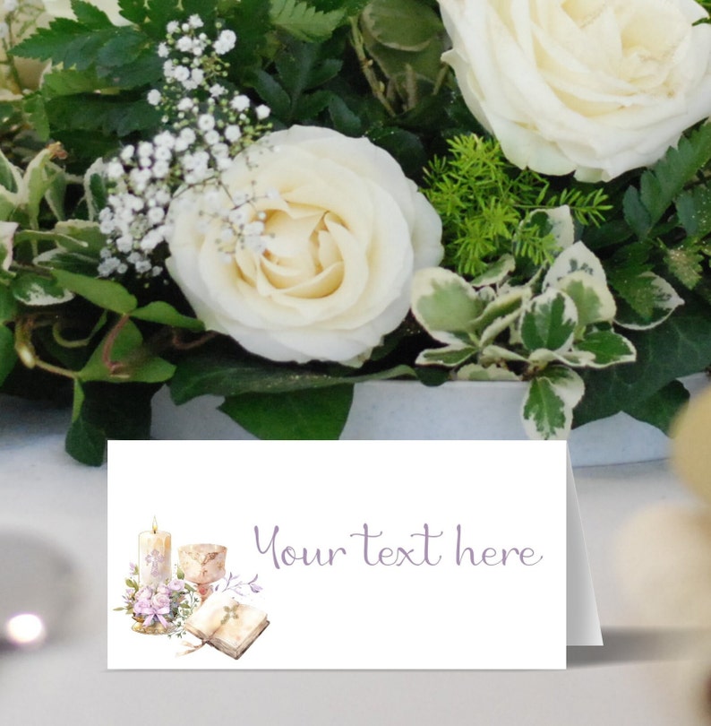 May include: White place card with a watercolor illustration of a candle, chalice, and open book. The text "Your text here" is printed in purple.