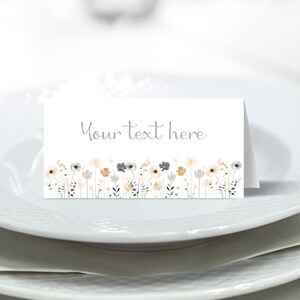 May include: A white place card with a gray floral border and the text "Your text here".