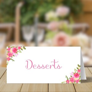 May include: A white card with pink floral borders and the word "Desserts" written in pink script.
