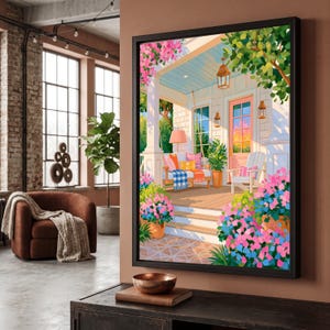 Op de afbeelding: Een ingelijste kunstdruk met een veranda-scène met een houten schommel, een witte stoel en levendige roze en blauwe bloemen. De veranda heeft een lichtblauw plafond, hangende lantaarns en een roze deur in een kleurrijke schilderstijl.