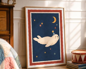 May include: A framed wall art print featuring a cream-coloured seal wearing a blue party hat, floating in a dark blue night sky with a yellow crescent moon and colourful stars, surrounded by a scalloped white and red patterned border.