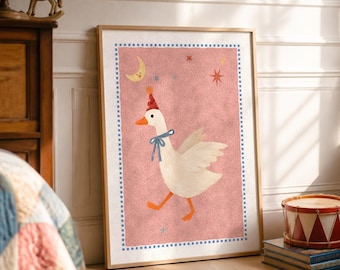 May include: A framed wall art print featuring a white goose wearing a red party hat and a blue ribbon around its neck. The background is a textured pink with a yellow crescent moon, small stars, and a blue and white checkered border.