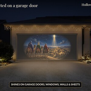 May include: A projector display showing a nativity scene with three figures on camels travelling towards a bright star over a town. The text Projected on a garage door and HollowlightFX appear, with a label stating SHINES ON GARAGE DOORS, WINDOWS, WALLS & SHEETS.