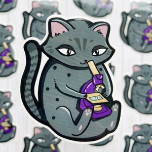 May include: A gray cat with pink ears and a black nose is holding a purple microscope. The cat is sitting on a white background.