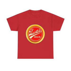 May include: A red t-shirt featuring a circular logo for Bartels Beer. The logo has a gold border with red and white text. The shirt is made of a soft material.
