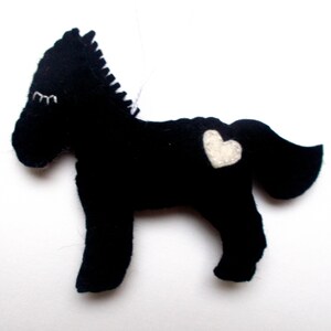 May include: Black felt horse ornament with a white felt heart on its side.