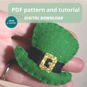 May include: A green felt leprechaun hat with a black band and gold buckle. The hat is embellished with glitter and is a digital download. Text on the image reads "PDF pattern and tutorial" and "Digital Download".
