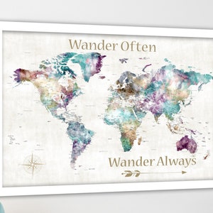 May include: A watercolor world map with a white background and a white frame. The map is decorated with colorful watercolor washes in shades of purple, teal, and brown. The text "Wander Often" is at the top of the map and "Wander Always" is at the bottom of the map.