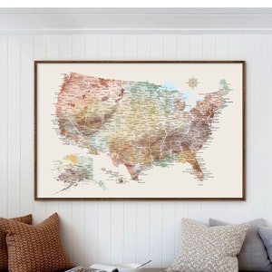 May include: A framed watercolor map of the United States with the names of all the states and major cities. The map is in shades of brown, green, and blue.