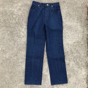 May include: A pair of dark blue denim jeans with a high waist and straight legs.