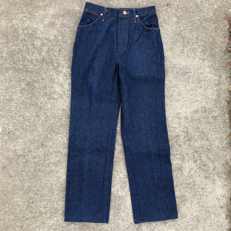 May include: A pair of dark blue denim jeans with a high waist and straight legs.