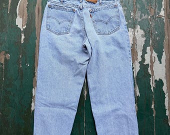 Vintage 1990s Levi 550 orange tab jeans in 30