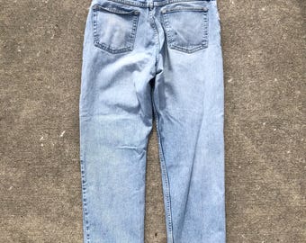 vintage 1990s lightwash distressed relaxed fit wide leg jeans by Wrangler