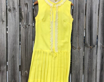 1970s yellow crepe pleated mini dress with ruffle and bow, drop waist