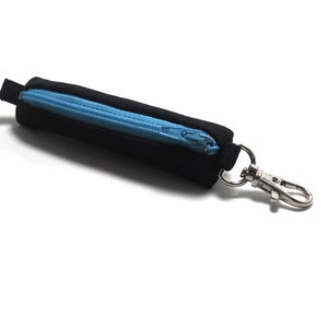May include: A black zippered pouch with a blue zipper and a silver metal clip. The pouch is about 5 inches long.
