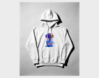 May include: A white hooded sweatshirt featuring a graphic print on the chest. The design depicts a blue teacup overflowing with a colorful, brain-shaped cloud of smoke and the text The ADHD Teacup in a stylized pink and blue font.