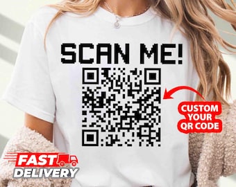 May include: White t-shirt with the text "SCAN ME!" and a black and white QR code. The text "CUSTOM YOUR QR CODE" is written in a red box next to the QR code.