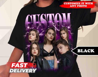 May include: Black t-shirt with a purple "CUSTOM" graphic featuring four women in a collage. The women are wearing black clothing and have a purple and pink background with lightning bolts.