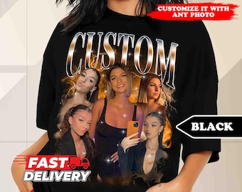 May include: Black t-shirt with the word "CUSTOM" printed in silver and gold letters. The shirt features a collage of four women's faces with a glittery background. The text "CUSTOMIZE IT WITH ANY PHOTO" is printed in white on a black rectangle at the top of the image. The text "BLACK" is printed in white on a black rectangle at the bottom of the image.