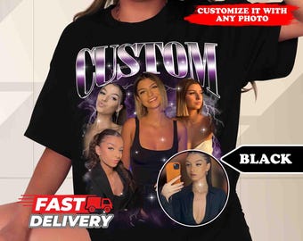 May include: Black t-shirt with a graphic print of the word "CUSTOM" in a purple and white design. The graphic also features four women's faces with a lightning bolt effect.