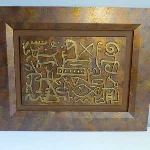 May include: A framed artwork with a brown background and a gold metallic design of abstract symbols and figures. The frame is a rustic brown with a textured finish.
