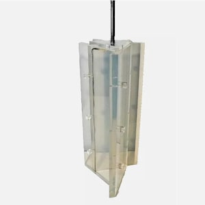 May include: A clear plastic mold with a hinged design, perfect for creating candles or soap. The mold is suspended from a black cord.