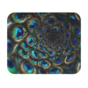 May include: A rectangular item with a peacock feather design. The image shows a close-up of the feathers, arranged in a spiral pattern. The design features shades of blue, teal, and brown. The intricate details and colour variations of the feathers are clearly visible.