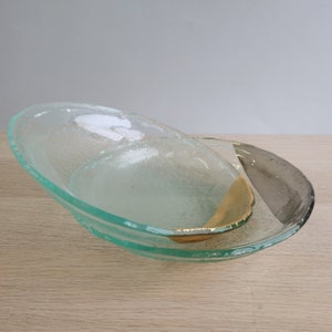 May include: Two clear glass bowls with a textured surface. The top bowl has a gold accent and the bottom bowl has a gray accent.