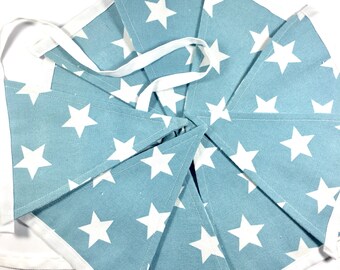 May include: A blue and white bunting with white stars on a blue background. The bunting is made of fabric and has a white trim.